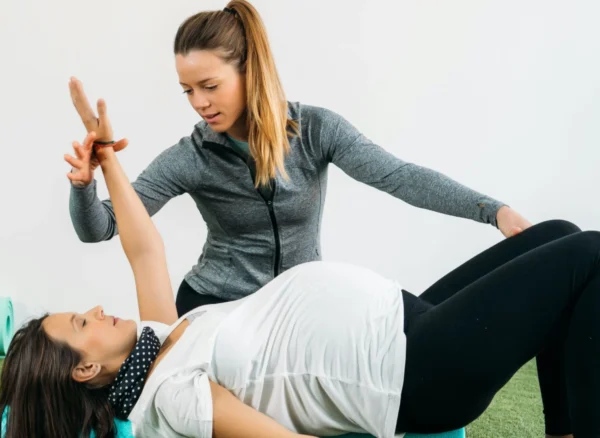 Therapist helping woman do physiotherapy in Vancouver's Olympic Village