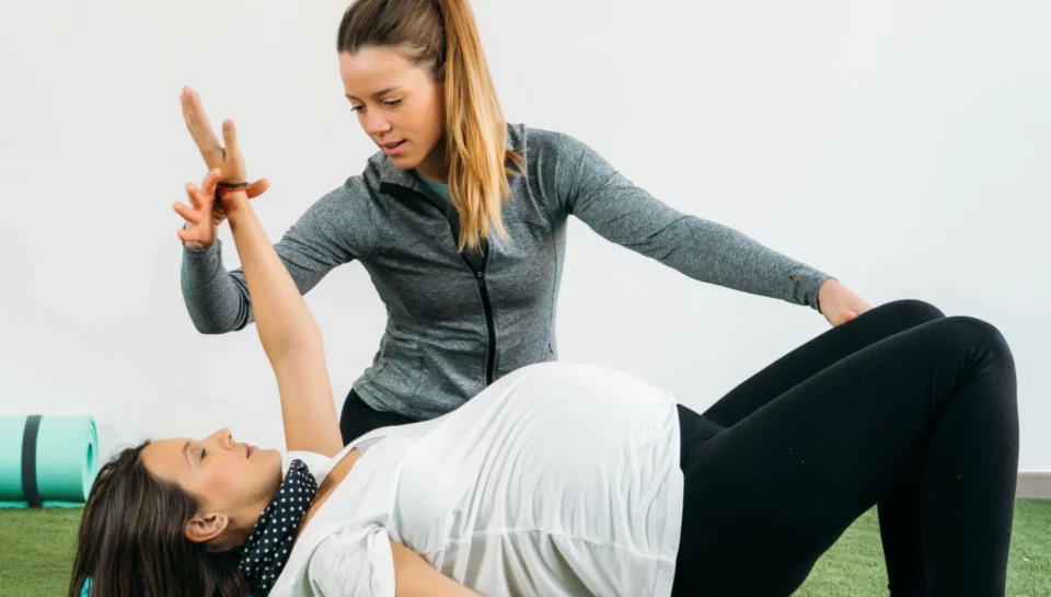 Therapist helping woman do physiotherapy in Vancouver's Olympic Village