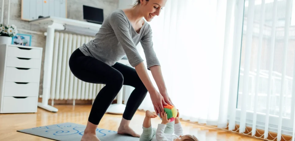 Woman doing post partum physiotherapy with her baby