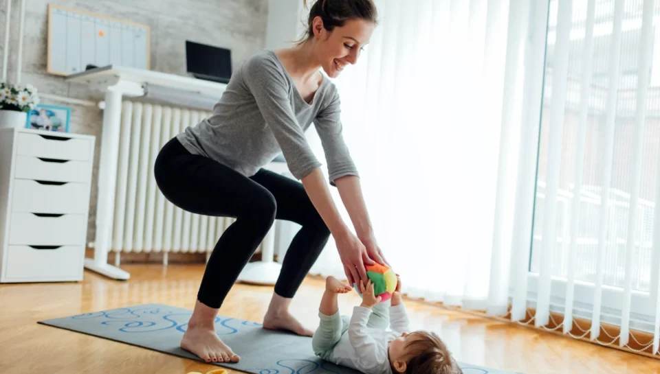 Woman doing post partum physiotherapy with her baby