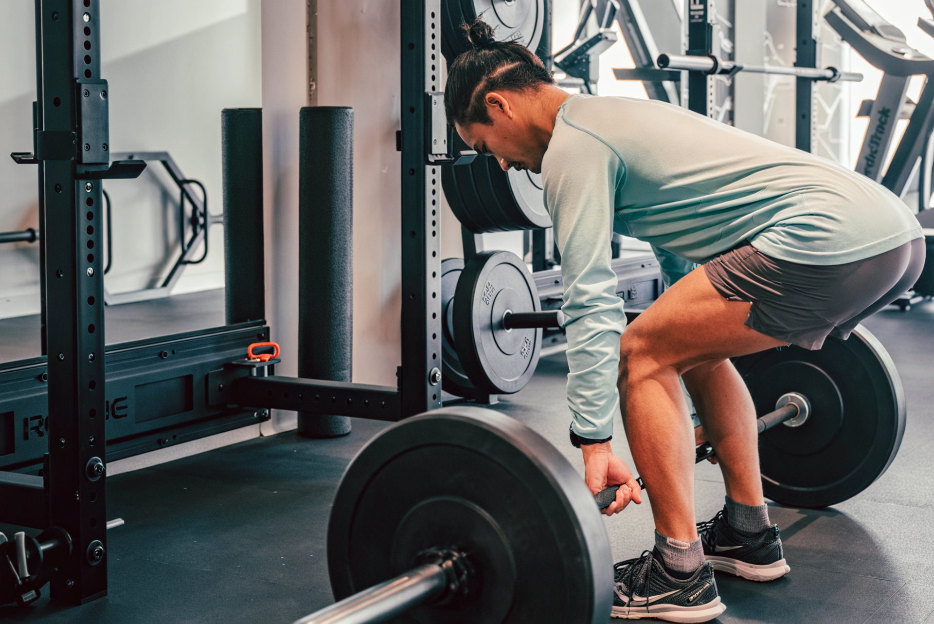 man picking up weights